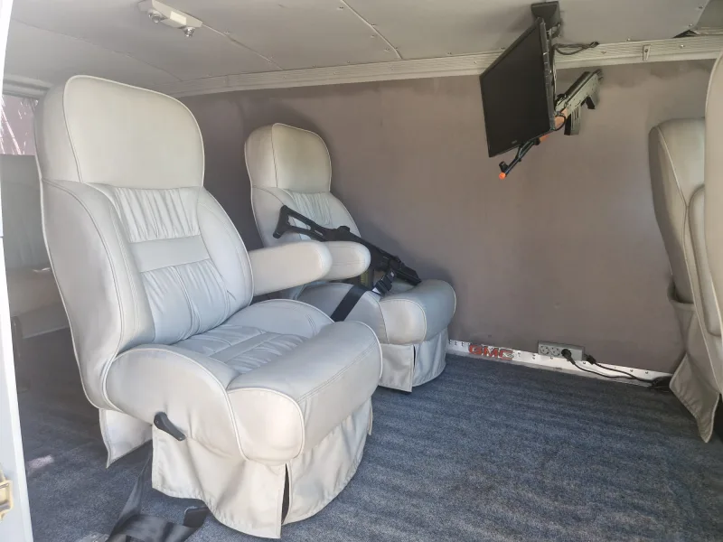 Light leather captain's chair and show props inside the van
