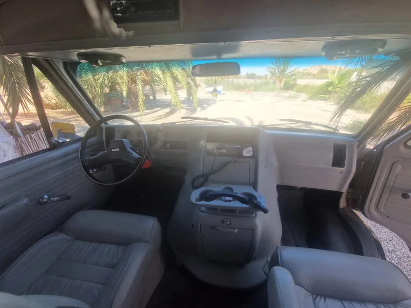 The van cab with the steering wheel, dashboard and CB radio