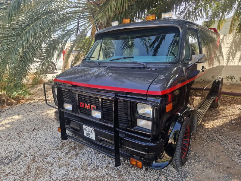 Three-quarter front view of the A-Team van under the palm trees