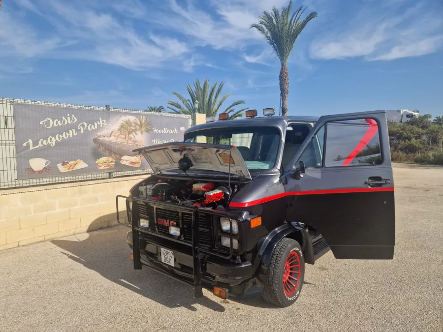 The A-Team van with its bonnet open showing the engine at a trade show